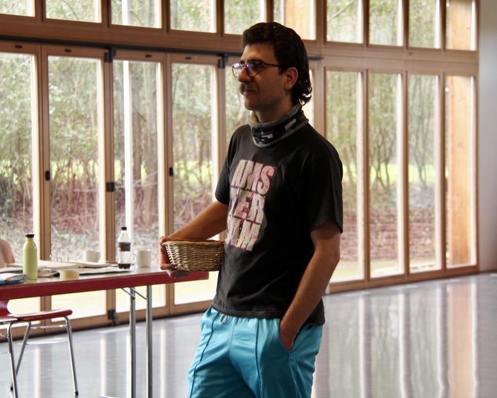A young man standing with a basket